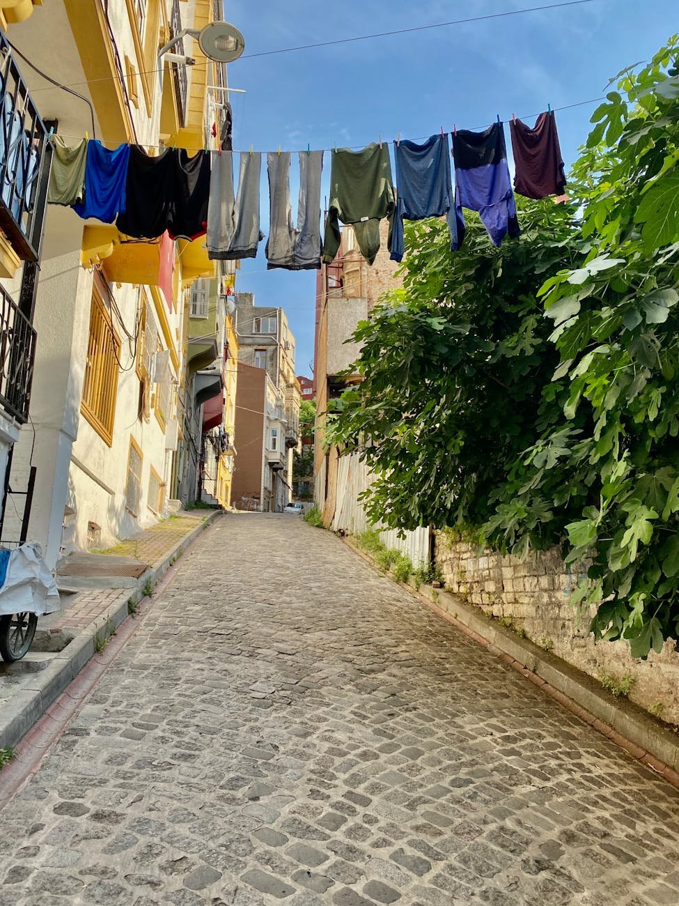 laundry hanging on washing line on an alley